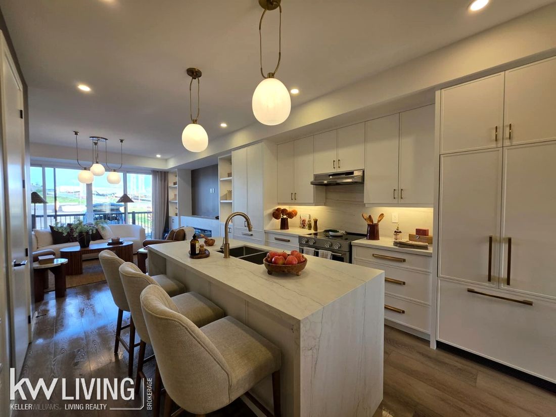 AVELLA model suite kitchen with waterfall quartz island